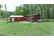 Backyard sheds and yard featuring outbuildings for storage and activities at 395 Moss Ferry Rd, Villa Rica, GA 30180