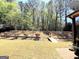 Beautiful backyard featuring mature trees, landscaping, and a small bridge leading to the lower part of the yard at 108 Stonecrest Dr, Carrollton, GA 30116