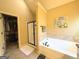 Bathroom featuring a bathtub, shower enclosure, and walk-in closet at 108 Stonecrest Dr, Carrollton, GA 30116