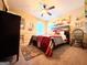 Bedroom with ceiling fan, bed and lots of wall decor at 108 Stonecrest Dr, Carrollton, GA 30116