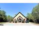 Community clubhouse with stone accents and gated entry, offering a space for gatherings and recreation at 108 Stonecrest Dr, Carrollton, GA 30116