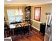 Comfortable dining area with a wooden table, six chairs, and a window with natural light at 108 Stonecrest Dr, Carrollton, GA 30116