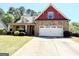 Charming two-story home with stone accents, a well-manicured lawn, and an attached two-car garage at 108 Stonecrest Dr, Carrollton, GA 30116