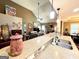 Open-concept living space with a kitchen island featuring stone counter tops seamlessly flowing to the living room at 108 Stonecrest Dr, Carrollton, GA 30116