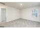 Neutral bedroom features neutral carpet, window, and doorway to hallway at 307 Limestone Circle, Conyers, GA 30013