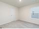 Cozy bedroom with neutral walls, plush carpeting, natural light from a window, and a convenient closet door at 307 Limestone Circle, Conyers, GA 30013