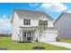 Charming two-story home with a two-car garage, well-maintained lawn, and dark shutters at 307 Limestone Circle, Conyers, GA 30013