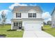 Charming two-story home with a two-car garage, well-maintained lawn, and dark shutters at 307 Limestone Circle, Conyers, GA 30013