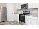 Close-up of kitchen with stainless steel appliances and granite countertops at 307 Limestone Circle, Conyers, GA 30013
