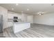 Open-concept living area features gray wood-look flooring, white cabinets, and granite countertops at 307 Limestone Circle, Conyers, GA 30013