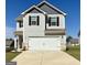 Two-story home featuring a white garage door, light gray siding, black shutters, and a well-maintained front yard at 458 Prescott Way, Villa Rica, GA 30180