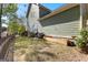 Well-maintained backyard with mature trees, a grill, and an outdoor cooking area with potted plants at 217 Christina Ct, Peachtree City, GA 30269