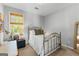 Comfortable bedroom with a metal bed frame, natural light, and a cozy reading nook at 217 Christina Ct, Peachtree City, GA 30269