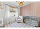 Cozy Bedroom showcasing a crib, comfortable chair, soft lighting, and stylish décor at 217 Christina Ct, Peachtree City, GA 30269
