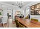 Open-concept dining room with a large wooden table, modern lighting, and staircase view at 217 Christina Ct, Peachtree City, GA 30269