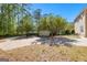Long driveway leading to the home's garage, surrounded by lush trees and manicured landscaping at 217 Christina Ct, Peachtree City, GA 30269