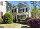 Charming two-story home with a green exterior, black shutters, and landscaped front yard at 217 Christina Ct, Peachtree City, GA 30269