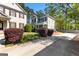 View of a two-story home with green siding, complemented by colorful landscaping and mature trees at 217 Christina Ct, Peachtree City, GA 30269