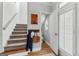 Hallway with staircase and access to a cute half-bath featuring modern fixtures and stylish decor at 217 Christina Ct, Peachtree City, GA 30269