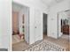 Hallway with neutral carpet leads to rooms, decorated with rugs and bright white doors at 217 Christina Ct, Peachtree City, GA 30269