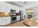 Charming kitchen with stainless appliances, granite counters, and access to the backyard at 217 Christina Ct, Peachtree City, GA 30269