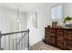 Upstairs landing with natural light and unique wooden storage cabinet at 217 Christina Ct, Peachtree City, GA 30269