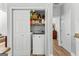 Functional laundry area with modern washer and dryer, plus convenient built-in shelving for organized storage at 217 Christina Ct, Peachtree City, GA 30269