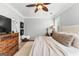 Comfortable main bedroom with ceiling fan, woven rug, and stylish wooden dresser at 217 Christina Ct, Peachtree City, GA 30269