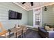 Relaxing sunroom with a TV, ceiling fan, string lights, and comfortable seating area at 217 Christina Ct, Peachtree City, GA 30269
