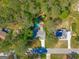 Aerial view of property showing house, driveway, and pool nestled among trees at 203 Silverwood Way, Peachtree City, GA 30269