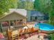Aerial view of backyard featuring an above ground pool, deck and patio area at 203 Silverwood Way, Peachtree City, GA 30269