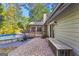 The backyard offers a brick patio, outdoor seating, and an above-ground swimming pool at 203 Silverwood Way, Peachtree City, GA 30269