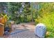 The outdoor area features a stone patio with a grill and a glimpse of the swimming pool at 203 Silverwood Way, Peachtree City, GA 30269