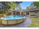 A backyard with an above-ground pool features a stone pathway leading to the house at 203 Silverwood Way, Peachtree City, GA 30269
