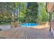 Backyard features a wooden deck and above ground pool surrounded by mature trees at 203 Silverwood Way, Peachtree City, GA 30269