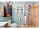 Clean bathroom with a shower and beige tiling, plus wood vanity and a toilet at 203 Silverwood Way, Peachtree City, GA 30269
