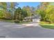 Well-maintained home featuring a lush green lawn and a paved driveway on a sunny day at 203 Silverwood Way, Peachtree City, GA 30269