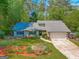 Charming single-story home with a well-manicured lawn and lush landscaping at 203 Silverwood Way, Peachtree City, GA 30269