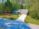 Charming single-story home with an attached garage on a tree-lined street at 203 Silverwood Way, Peachtree City, GA 30269
