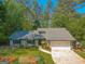 Charming home with lush landscaping, a gray roof, and inviting curb appeal at 203 Silverwood Way, Peachtree City, GA 30269