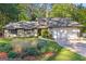 Charming home with lush landscaping, a gray roof, and inviting curb appeal at 203 Silverwood Way, Peachtree City, GA 30269