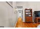 Long hallway featuring hardwood floors and easy access to other rooms at 203 Silverwood Way, Peachtree City, GA 30269