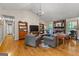 Open living room boasts hardwood floors, stone fireplace, vaulted ceiling, and natural light at 203 Silverwood Way, Peachtree City, GA 30269