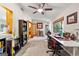 Bright living room with large windows, a ceiling fan, an exterior door, and a built-in bookcase at 203 Silverwood Way, Peachtree City, GA 30269