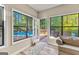 Sunroom view featuring an exterior door leading to a pool and a wooden deck with green forest views at 203 Silverwood Way, Peachtree City, GA 30269
