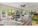 Sun Room with an exterior door, large windows, wood floor, and a tan-colored couch at 203 Silverwood Way, Peachtree City, GA 30269