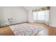 Bright bedroom featuring a large window, hardwood floors, and colorful area rug at 2550 Columbia Crossing Ct, Decatur, GA 30034