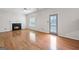 Bright living room with a fireplace, hardwood floors, and access to the backyard at 2550 Columbia Crossing Ct, Decatur, GA 30034