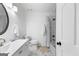 Bright, clean bathroom with white marble floors, white marble shower, and updated fixtures at 608 E Banks Rd, Fayetteville, GA 30214