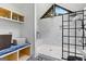Bright bathroom featuring a glass-enclosed shower and storage with a unique roof window at 608 E Banks Rd, Fayetteville, GA 30214